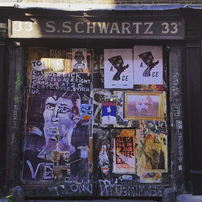 Posters and graffiti on a door in Fournier Street, Spitalfields
