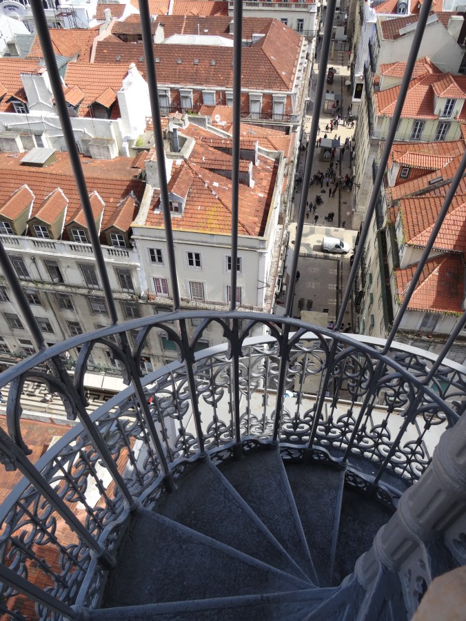 View of the ornate railings of the Santa Justa lift and down into Lisbon's streets below