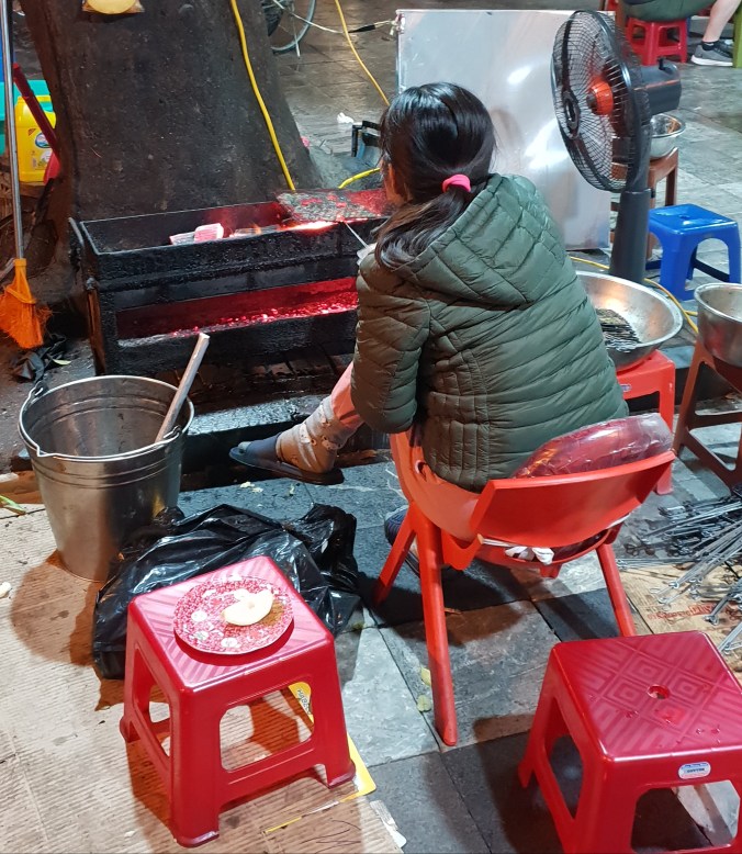 Cooking bun cha over coals