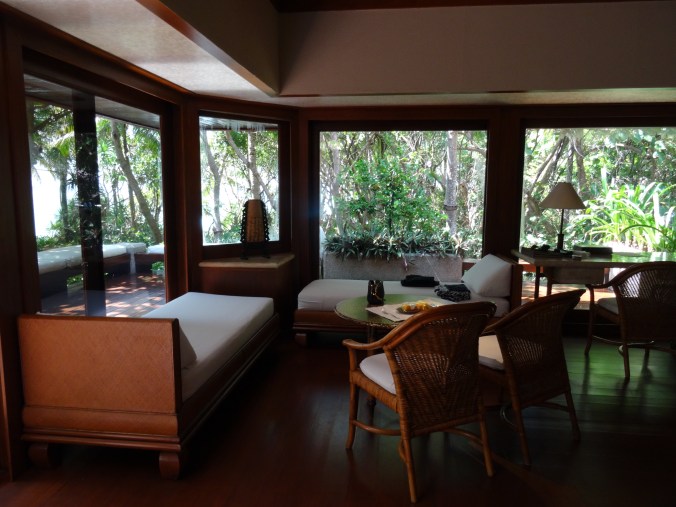 Seating area and indoor twin divans in a beach casita, Amanpulo